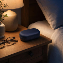 The Heration travel case on a bedside table by lamplight